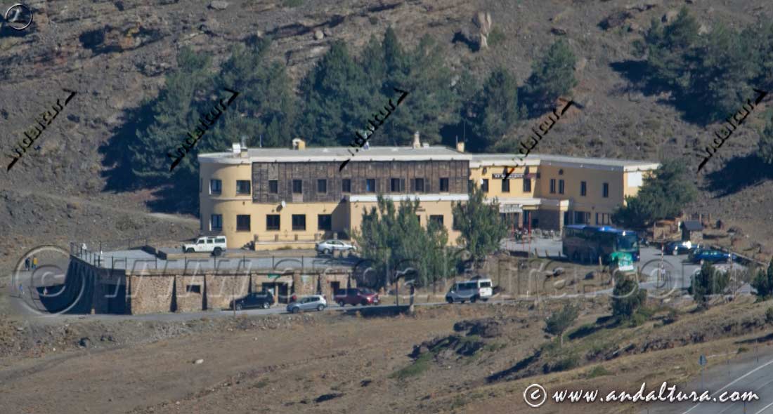 Autobús de la línea Granada-Sierra Nevada en verano junto al Albergue Universitario y la oficina de las Lanzaderas del SIAC al Veleta