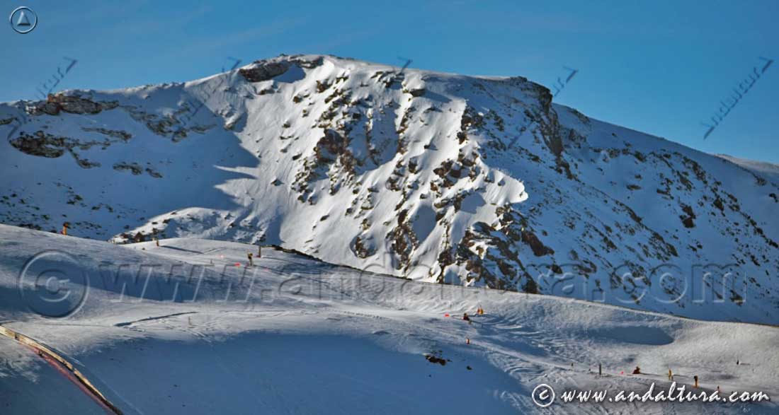 Parte alta de la pista Loma Dílar antes de adentrarse en el Valle, al fondo la silueta del Tozal del Cartujo