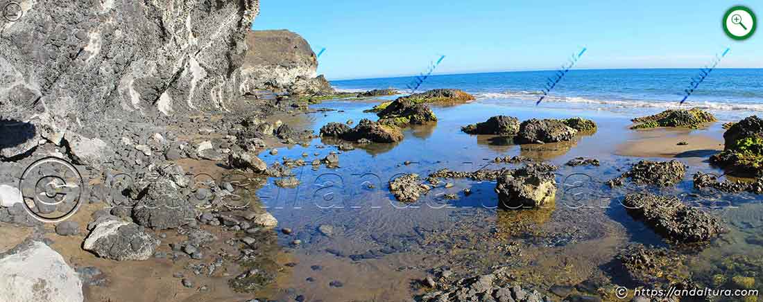 Acantilados volcánicos y bolos en el paso entre Cala Chica y Cala Grande del Barronal junto al mar Mediterráneo.